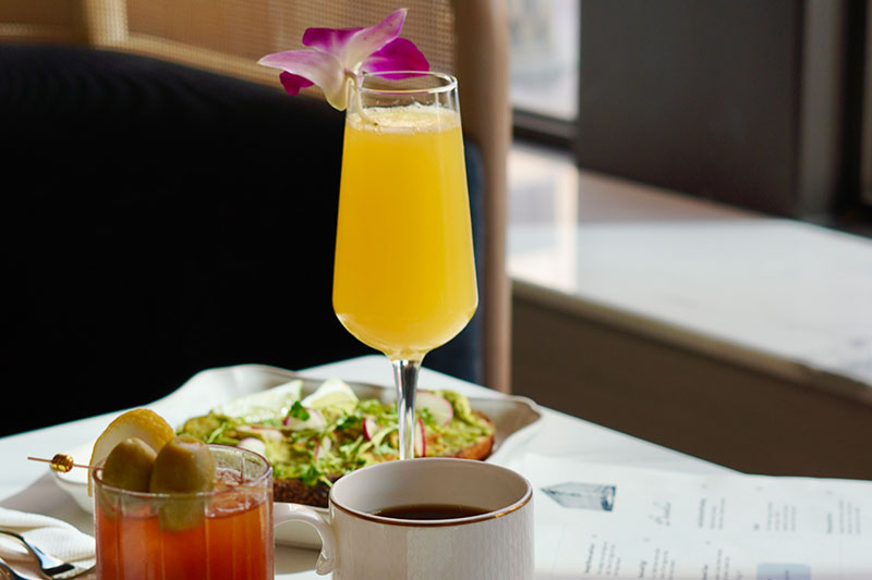 cocktail on table with brunch items