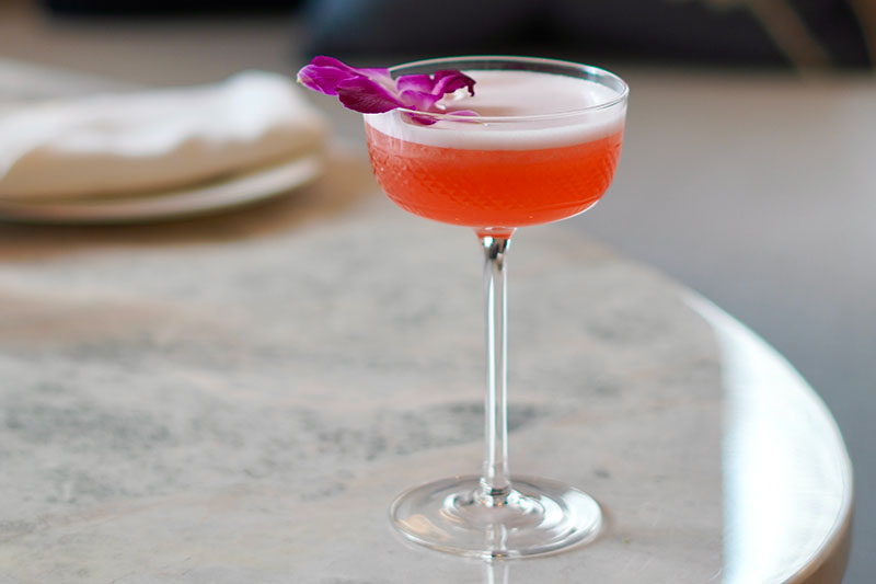 red cocktail with flower